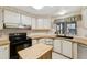 Efficient kitchen featuring a black stove, ample counter space, and a modern sink at 58 Lakeview Dr, North Port, FL 34287