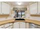 Efficient kitchen design featuring corner sink, modern appliances, and ample storage space at 58 Lakeview Dr, North Port, FL 34287