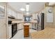 Well-equipped kitchen boasting a stainless steel refrigerator, black appliances, and an efficient island at 58 Lakeview Dr, North Port, FL 34287