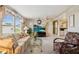 Bright living room with large windows offering natural light and access to other rooms in the house at 58 Lakeview Dr, North Port, FL 34287
