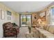 Comfortable living room with large windows, a ceiling fan, and glass sliding doors to an enclosed porch at 58 Lakeview Dr, North Port, FL 34287