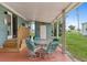 Relaxing covered porch with comfortable seating, perfect for enjoying the outdoors at 58 Lakeview Dr, North Port, FL 34287