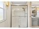 Bathroom featuring glass-enclosed shower with updated showerhead at 58 Lakeview Dr, North Port, FL 34287