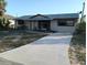 Charming single-story home with a well-maintained lawn and a concrete driveway leading up to the front entrance at 7321 Bolten Ln, Port Charlotte, FL 33981