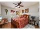 Cozy bedroom featuring a ceiling fan, natural light, and traditional decor at 7501 Mikasa Dr, Punta Gorda, FL 33950