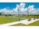Bocce ball courts in a community, featuring green space, benches, and a view of the surrounding neighborhood at 7501 Mikasa Dr, Punta Gorda, FL 33950