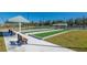 Bocce ball courts with seating and shade offer a relaxing recreational space with a view of the community pond at 7501 Mikasa Dr, Punta Gorda, FL 33950