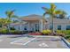 Community clubhouse with a covered entryway, palm trees, and accessible parking at 7501 Mikasa Dr, Punta Gorda, FL 33950