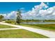 Scenic community pond with a fountain feature, walking path, and lush landscaping offering serene views at 7501 Mikasa Dr, Punta Gorda, FL 33950