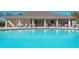Sparkling community pool featuring comfortable lounge chairs and clear blue water at 7501 Mikasa Dr, Punta Gorda, FL 33950