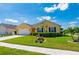 Well-manicured lawn and tidy flowerbeds surround this charming single-story home at 7501 Mikasa Dr, Punta Gorda, FL 33950