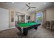 The game room features a pool table, seating, and natural light creating a fun and inviting space at 7501 Mikasa Dr, Punta Gorda, FL 33950