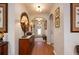 Hallway with wood flooring, neutral walls, decorative furnishings, and archway into living area at 7501 Mikasa Dr, Punta Gorda, FL 33950