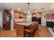 Spacious kitchen features a large island, granite countertops, wood cabinets, and stainless steel appliances at 7501 Mikasa Dr, Punta Gorda, FL 33950