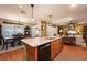 Open kitchen with island, granite countertops, and views of the dining and living area at 7501 Mikasa Dr, Punta Gorda, FL 33950