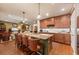 Open kitchen with island, granite countertops, seating, and views of the living area at 7501 Mikasa Dr, Punta Gorda, FL 33950
