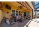 Cozy, covered lanai featuring wicker seating, ceiling fan, and mounted television for ultimate relaxation at 7501 Mikasa Dr, Punta Gorda, FL 33950