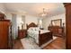 Elegant bedroom features wood furniture, soft lighting, and hardwood floors at 7501 Mikasa Dr, Punta Gorda, FL 33950