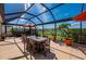 Spacious screened patio features a dining table, outdoor furniture, and a backyard view, perfect for entertaining at 7501 Mikasa Dr, Punta Gorda, FL 33950