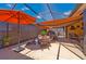 Enclosed patio featuring comfortable seating, outdoor umbrellas, and shade for relaxing or entertaining at 7501 Mikasa Dr, Punta Gorda, FL 33950