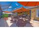 Enclosed patio featuring comfortable seating, outdoor umbrellas, and shade for relaxing or entertaining at 7501 Mikasa Dr, Punta Gorda, FL 33950
