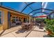 Outdoor patio with screened enclosure, featuring dining and seating areas plus access to the covered lanai at 7501 Mikasa Dr, Punta Gorda, FL 33950