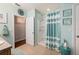 Well-lit bathroom features a tiled shower with glass enclosure and coastal-themed decor at 7501 Mikasa Dr, Punta Gorda, FL 33950