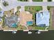 Aerial view of waterfront home with a screened pool, boat dock, canal access, and well-maintained landscaping at 931 Cimarron Dr, Punta Gorda, FL 33950