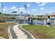 Waterfront backyard featuring a boat lift, dock, and walkway to the canal, perfect for boating enthusiasts at 931 Cimarron Dr, Punta Gorda, FL 33950