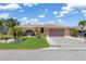 Charming single-story home with a well-manicured lawn, mature palm trees, and a two-car garage at 931 Cimarron Dr, Punta Gorda, FL 33950