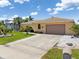 Charming single-story home featuring a tile roof and well-manicured lawn at 931 Cimarron Dr, Punta Gorda, FL 33950