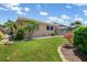 Beautiful home featuring a well-manicured lawn and landscaping, with a view of the screened-in lanai at 931 Cimarron Dr, Punta Gorda, FL 33950