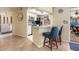Kitchen featuring modern bar seating, stainless appliances, and opening to main living area at 931 Cimarron Dr, Punta Gorda, FL 33950
