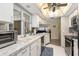 Well-lit kitchen showcasing white cabinets, stainless steel dishwasher and microwave, and granite countertops at 931 Cimarron Dr, Punta Gorda, FL 33950
