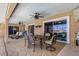 Outdoor dining and living space with ceiling fans and views of the pool and waterfront at 931 Cimarron Dr, Punta Gorda, FL 33950