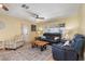 Comfortable living room with tile floors, ceiling fan, and bright light from the windows at 931 Cimarron Dr, Punta Gorda, FL 33950