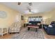 Comfortable living room featuring tile flooring, ceiling fan, and plenty of natural light at 931 Cimarron Dr, Punta Gorda, FL 33950