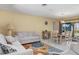Comfortable living room featuring tile floors, a large window, and access to the lanai at 931 Cimarron Dr, Punta Gorda, FL 33950