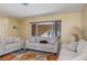 Bright living room with neutral paint, white sofas, and a large window overlooking the front yard at 931 Cimarron Dr, Punta Gorda, FL 33950