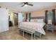 This spacious bedroom features an ensuite bath with sliding door, tile floors, and a neutral color palette at 931 Cimarron Dr, Punta Gorda, FL 33950