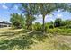 Lush backyard with mature trees offers privacy and a serene outdoor setting at 9850 Fiddlers Green Cir # 130, Rotonda West, FL 33947
