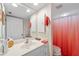 Bathroom featuring a white vanity, a mirror, and a shower with bright orange curtain at 9850 Fiddlers Green Cir # 130, Rotonda West, FL 33947