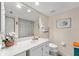 Bright bathroom with a white vanity, a large mirror, and tile floors at 9850 Fiddlers Green Cir # 130, Rotonda West, FL 33947