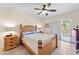 Comfortable bedroom featuring a ceiling fan, natural light, a dresser, and private access to the patio at 9850 Fiddlers Green Cir # 130, Rotonda West, FL 33947