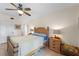 Bright bedroom featuring tile floors, a ceiling fan, and a charming wood bed frame at 9850 Fiddlers Green Cir # 130, Rotonda West, FL 33947