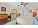 Well-lit bedroom showcasing neutral walls, a ceiling fan, and a wooden dresser with a mirror at 9850 Fiddlers Green Cir # 130, Rotonda West, FL 33947