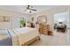 Bright bedroom with ceiling fan, dresser, view of the patio, and neutral wall color at 9850 Fiddlers Green Cir # 130, Rotonda West, FL 33947