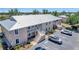 Exterior of building featuring balconies, stairs, and parking lot surrounded by landscaping at 9850 Fiddlers Green Cir # 130, Rotonda West, FL 33947