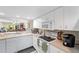 Bright kitchen with white appliances and access to the living area at 9850 Fiddlers Green Cir # 130, Rotonda West, FL 33947