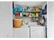 Organized laundry closet featuring wire shelving above a stacked washer and dryer unit at 9850 Fiddlers Green Cir # 130, Rotonda West, FL 33947